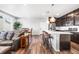 Open-concept kitchen with modern island, pendant lighting, stainless steel appliances, and hardwood floors at 21413 E 59Th Pl, Aurora, CO 80019