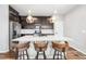 Well-equipped kitchen with center island, stainless steel appliances, dark cabinets, and stylish pendant lights at 21413 E 59Th Pl, Aurora, CO 80019