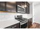 Gourmet kitchen with stainless steel appliances, a gas range, and white countertops at 21413 E 59Th Pl, Aurora, CO 80019