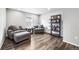 Cozy living room with neutral gray tones, plush seating, and modern shelving at 21413 E 59Th Pl, Aurora, CO 80019