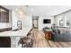 Open-concept living space with kitchen island, barstool seating, and a cozy living room area at 21413 E 59Th Pl, Aurora, CO 80019