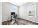 Bright home office with modern desk setup, laminate floors, and natural light from two windows at 21413 E 59Th Pl, Aurora, CO 80019