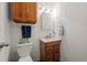 Cozy bathroom featuring a wood vanity, medicine cabinet, and a convenient toilet at 4550 E 121St Pl, Thornton, CO 80241