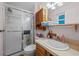Functional bathroom features a shower with sliding glass doors, toilet and vanity with sink at 4550 E 121St Pl, Thornton, CO 80241