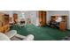 Cozy living room featuring classic green carpeting and a sunlit dining area at 4550 E 121St Pl, Thornton, CO 80241