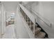 White staircase leads to the upper level, showcasing a neutral interior design at 4550 E 121St Pl, Thornton, CO 80241