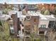 Aerial view of a modern townhome with a rooftop deck and outdoor fireplace at 8071 E 29Th Ave, Denver, CO 80238