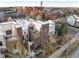 Aerial view of a modern townhome community with rooftop decks and mature trees at 8071 E 29Th Ave, Denver, CO 80238