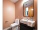 Modern powder room with stylish fixtures, unique mirror, and custom design at 8071 E 29Th Ave, Denver, CO 80238