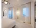 Airy bedroom boasting ample natural light, light walls, a ceiling fan, and access to an outdoor terrace at 8071 E 29Th Ave, Denver, CO 80238