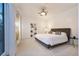 Bright primary bedroom with white walls, a comfortable bed, and sheer curtains at 8071 E 29Th Ave, Denver, CO 80238