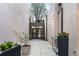 Inviting courtyard with potted plants and a table, providing a tranquil transition to the main entrance at 8071 E 29Th Ave, Denver, CO 80238