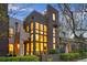 Modern brown and tan townhome with large windows and manicured landscaping at 8071 E 29Th Ave, Denver, CO 80238