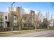 Eye-level exterior shot of a modern townhome with clean lines and manicured landscaping at 8071 E 29Th Ave, Denver, CO 80238