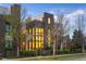 Modern brown and tan townhome with large windows and manicured landscaping at 8071 E 29Th Ave, Denver, CO 80238