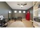 Well-lit room with versatile use, equipped with workout gear, a vintage fridge, and ample storage space at 8071 E 29Th Ave, Denver, CO 80238