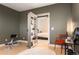 Versatile flex room with gym equipment, a large rug, and an adjacent bedroom with a hidden bookshelf door at 8071 E 29Th Ave, Denver, CO 80238