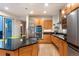 Updated kitchen with stainless steel appliances, a center island, and natural light at 8071 E 29Th Ave, Denver, CO 80238