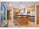 Gourmet kitchen with stainless steel appliances, island with bar seating, and modern lighting at 8071 E 29Th Ave, Denver, CO 80238