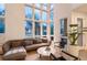 Bright living room featuring floor-to-ceiling windows, modern decor, and hardwood floors at 8071 E 29Th Ave, Denver, CO 80238