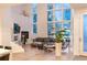 Bright living room with fireplace, high windows, modern furnishings, and an open staircase at 8071 E 29Th Ave, Denver, CO 80238