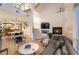 Open-concept living room with a fireplace, stairs, and view into adjacent kitchen at 8071 E 29Th Ave, Denver, CO 80238