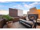 Inviting outdoor patio with comfortable seating and a cozy fireplace, perfect for entertaining at 8071 E 29Th Ave, Denver, CO 80238