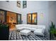 Stylish patio with a geometric patterned rug, a modular white sofa, and access to the home's interior at 8071 E 29Th Ave, Denver, CO 80238