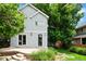 Exterior view of a house with a patio and lush landscaping in the backyard at 2485 S Fillmore St, Denver, CO 80210