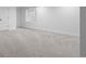Spacious basement area with neutral carpet, white walls, and a window for natural light at 2485 S Fillmore St, Denver, CO 80210