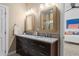 Bathroom featuring granite countertops, double sinks, wood framed mirrors, and modern fixtures at 2485 S Fillmore St, Denver, CO 80210