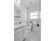 Clean bathroom featuring black and white tile, modern fixtures, and neutral paint at 2485 S Fillmore St, Denver, CO 80210