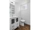 Contemporary bathroom with modern vanity, glass cabinet doors and hexagonal floor tiles at 2485 S Fillmore St, Denver, CO 80210