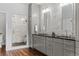 Bright bathroom featuring double sinks, a glass enclosed shower, and sleek cabinetry at 2485 S Fillmore St, Denver, CO 80210