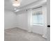Bright bedroom featuring white walls, gray carpet, and a window with white curtains at 2485 S Fillmore St, Denver, CO 80210
