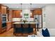 Beautiful kitchen with wooden cabinets, stainless steel appliances, and an island with seating at 2485 S Fillmore St, Denver, CO 80210
