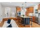 Open-concept kitchen featuring an island with seating, stainless appliances and wood cabinets at 2485 S Fillmore St, Denver, CO 80210