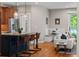 Spacious kitchen featuring an island with seating, and view into living room at 2485 S Fillmore St, Denver, CO 80210