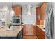 Updated kitchen featuring stainless steel appliances, granite countertops, and custom wood cabinets at 2485 S Fillmore St, Denver, CO 80210