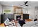 Living room featuring a stone fireplace, white sofa, and hardwood flooring at 2485 S Fillmore St, Denver, CO 80210