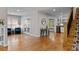 Open-concept living room with wood floors and access to other living areas at 2485 S Fillmore St, Denver, CO 80210