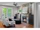 Elegant living room featuring a stone fireplace, white sofa, and hardwood flooring at 2485 S Fillmore St, Denver, CO 80210