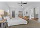 Bright main bedroom featuring plush carpet, a ceiling fan, and lots of natural light at 2485 S Fillmore St, Denver, CO 80210