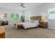 Bright main bedroom featuring plush carpet, a ceiling fan, and lots of natural light at 2485 S Fillmore St, Denver, CO 80210