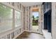 Mud room with wood floors, stylish wallpaper, and a convenient entry door at 2485 S Fillmore St, Denver, CO 80210