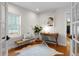 Bright office with hardwood floors, desk, chair, and a bench near the window at 2485 S Fillmore St, Denver, CO 80210