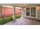 Covered patio with slate tile flooring, elegant lighting, and a beautiful brick wall at 2485 S Fillmore St, Denver, CO 80210