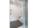 The glass enclosed shower features tile, a bench, and a ceiling-mounted shower head at 2485 S Fillmore St, Denver, CO 80210