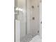 Modern walk-in shower featuring gray stone tile and pebble floor at 2485 S Fillmore St, Denver, CO 80210