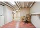 Basement featuring a work table, an extra space with carpet, and an exposed ceiling at 6404 Silver Mesa Dr # E, Highlands Ranch, CO 80130